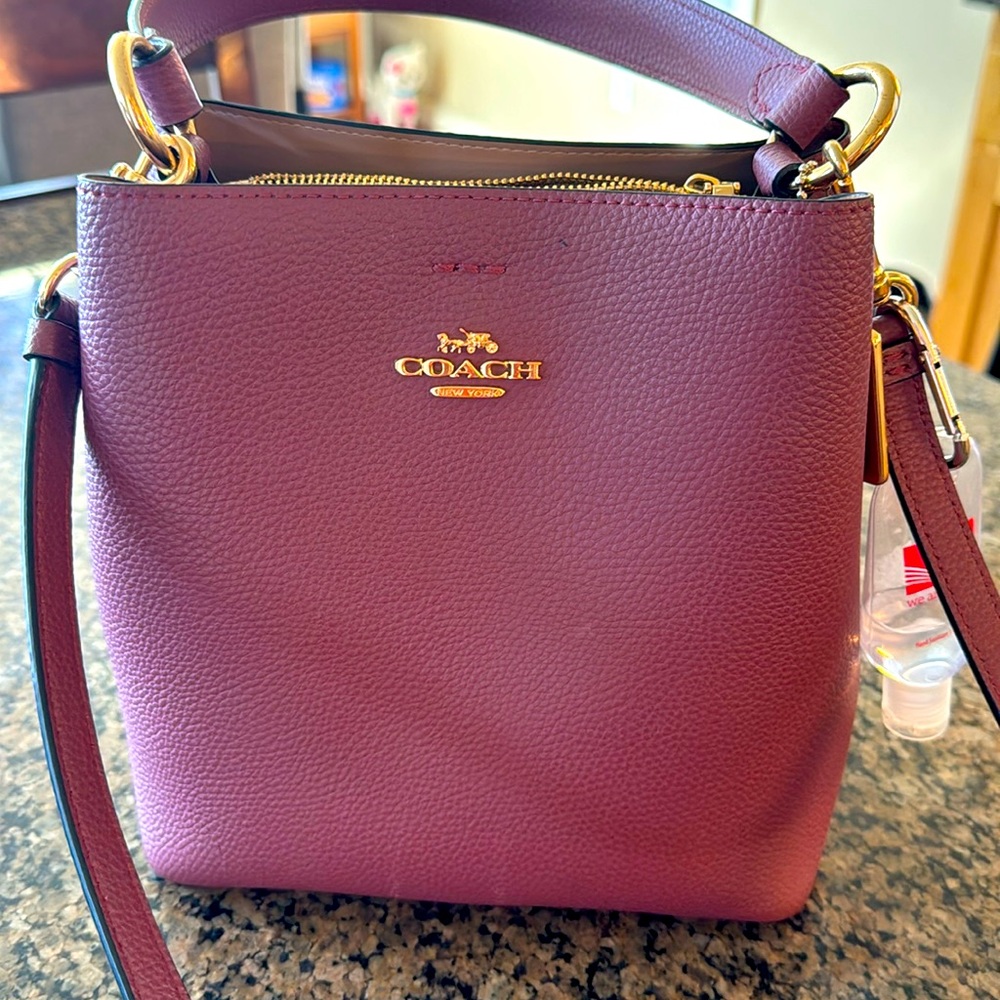 Like new Coach cross body. Color is more like a burgundy.